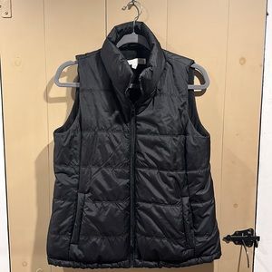 Black vest. Insulated/lined with soft material.